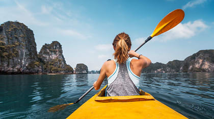 Woman kayaking in Ha Long Bay, Vietnam