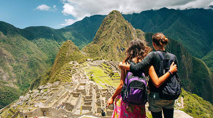 Couple looking at the lost city of the Incas, Machu Picchu in Peru Couple looking at the lost city of the Incas, Machu Picchu in Peru