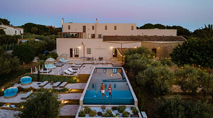 Romantic Sicily Wine Tour Couple at a luxury resort pool surrounded by vineyards in Selinunte, Sicily