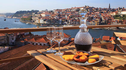 Table set with wine and pastries overlooking Porto, Portugal