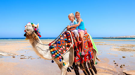 Sharm El Sheikh, Egypt Sisters riding camel on the beach in Egypt