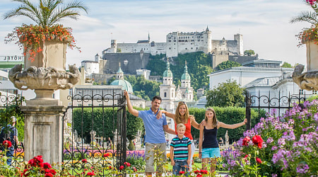 Family in Salzburg, Austria. Photo courtesy of Tourismus Salzburg Family on vacation in Salzburg, Austria posing with Hohensalzburg in the background