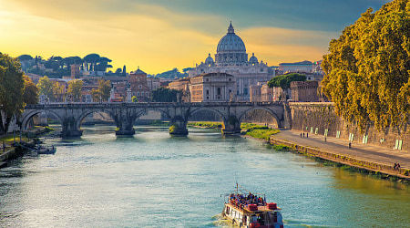 Boat sailing on Tiber River with Saint Peter's Basilica in Rome, Italy Boat sailing on Tiber River with Saint Peter's Basilica in Rome, Italy