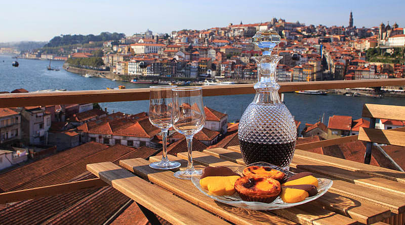 Table set with wine and pastries overlooking Porto, Portugal