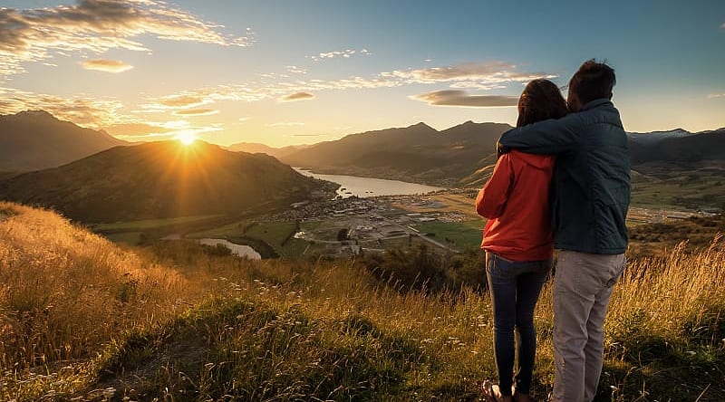 Couple enjoying a sunset in New Zealand Couple enjoying a sunset in New Zealand