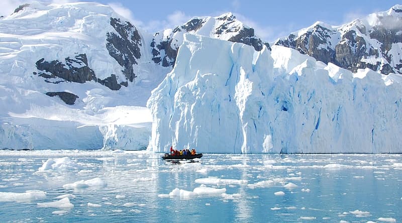 Exploring iceberg off the coast of Antarctica Exploring iceberg off the coast of Antarctica