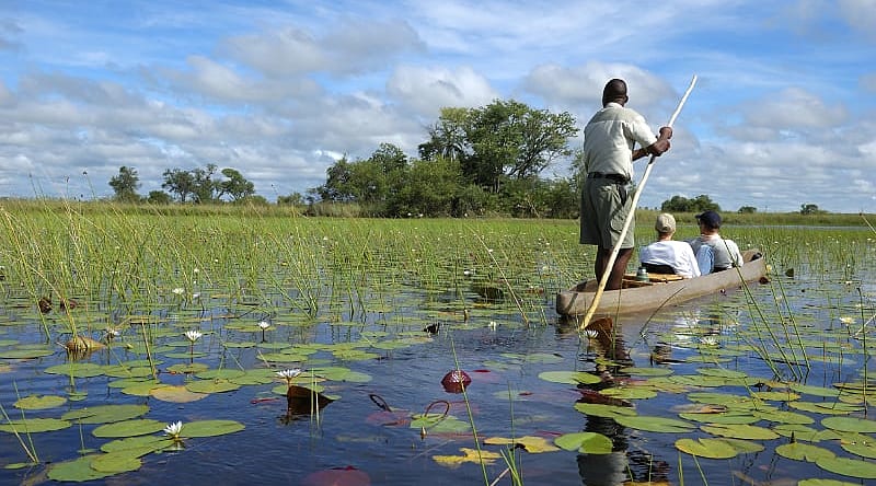 Mokoro ride on the Okavango Delta River in Botswana Mokoro ride on the Okavango Delta River in Botswana