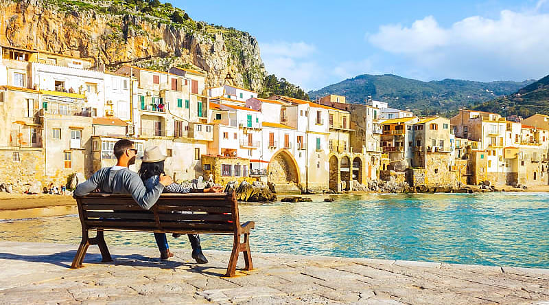 Traveling couple on the waterfront, Sicily Traveling couple on the waterfront, Sicily