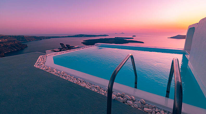 Athens & Santorini Honeymoon Package - Infinity pool overlooking the Aegean Sea at sunset in Santorini, Greece