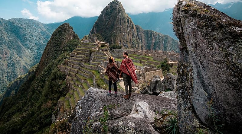 Couple at the great Inca city of Machu Picchu in Peru Couple at the great Inca city of Machu Picchu in Peru