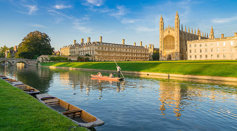 Cam River in Cambridge, England Couple punting on Cam River in Cambridge, England