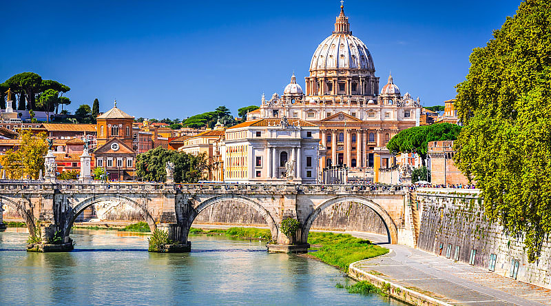 Vatican Dome of San Pietro Basilica and the Sant'Angelo bridge over Tiber river in Rome, Italy. Vatican Dome of San Pietro Basilica and the Sant'Angelo bridge over Tiber river in Rome, Italy.