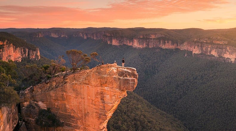 Hanging Rock in the Blue Mountains. Photo courtesy of Tourism Australia Hiker at Hanging Rock in the Blue Mountains, Australia