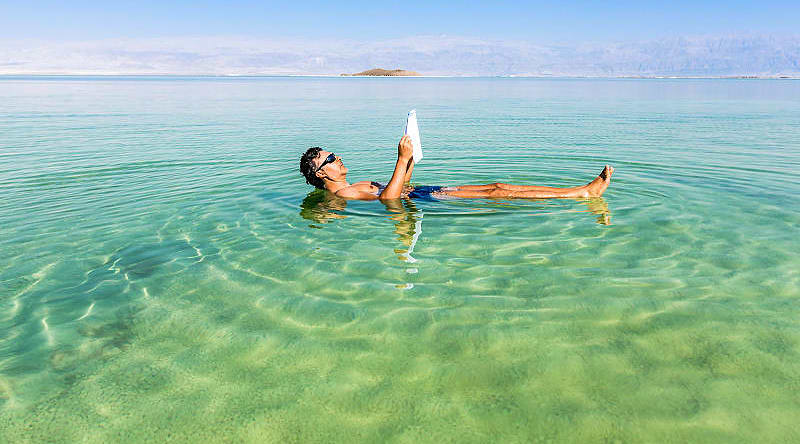 Dead Sea, Israel Tourist floating on the Dead Sea in Israel