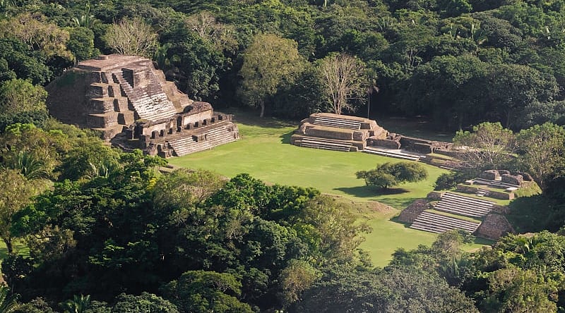 Mayan temples rise above the treetops like ancient skyscrapers. Mayan temples rise above the treetops like ancient skyscrapers.