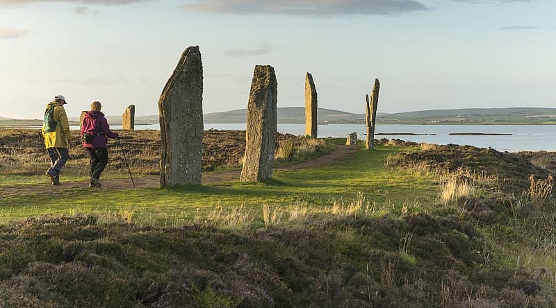 Ring of Brodger in Orkeny. Photo courtesy of Visit Scotland Senior couple hiking at the Ring of Brodger in Orkeny, Scotland