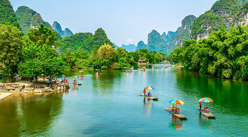 Guilin, China Tourists on bamboo boats floating down the Li River between the karsts in Guilin, China