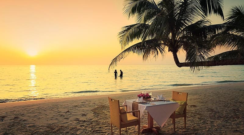 Honeymoon couple enjoying a romantic dinner on the beach in Costa Rica Honeymoon couple enjoying a romantic dinner on the beach in Costa Rica