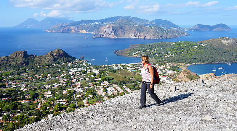 Woman hiking on the Gran Crater on Vulcano, on of seven Aeolian Island in Sicily, Italy Woman hiking on the Gran Crater on Vulcano, on of seven Aeolian Island in Sicily, Italy