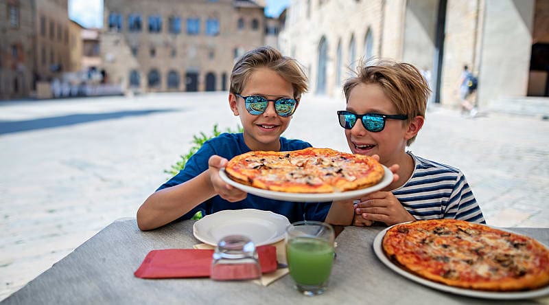 Boys enjoying a delicious Italian pizza. Boys enjoying a delicious Italian pizza.