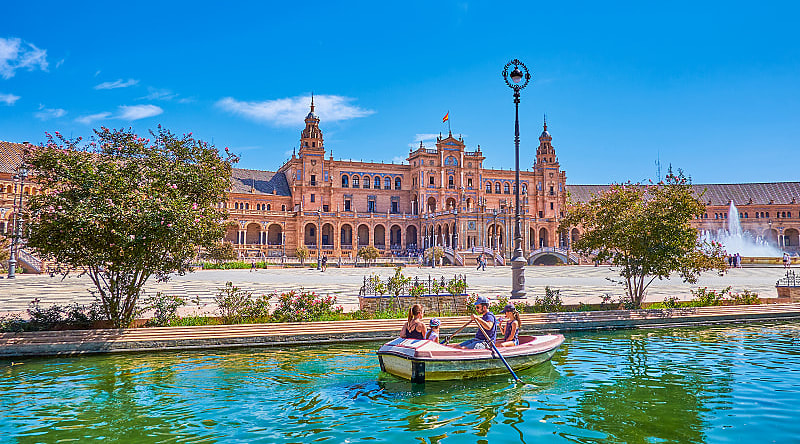 Plaza de Espana in Seville, Spain Family boating in the canal at Plaza de Espana in Seville, Spain