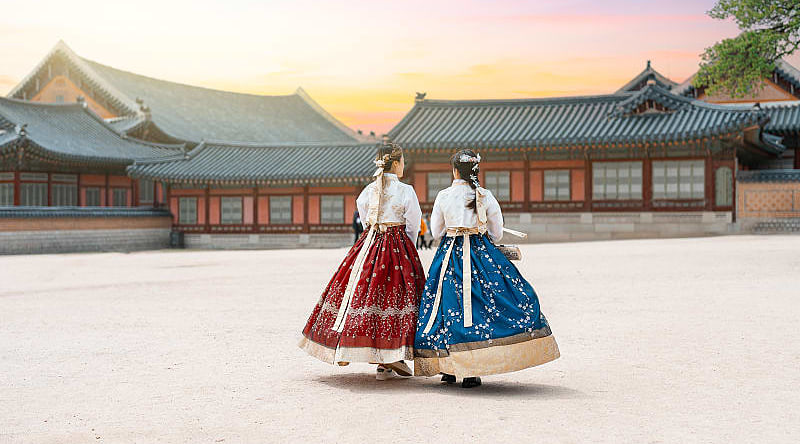 Women in hanbok stroll through the traditional-style homes in Seoul’s village. Women in hanbok stroll through the traditional-style homes in Seoul’s village.