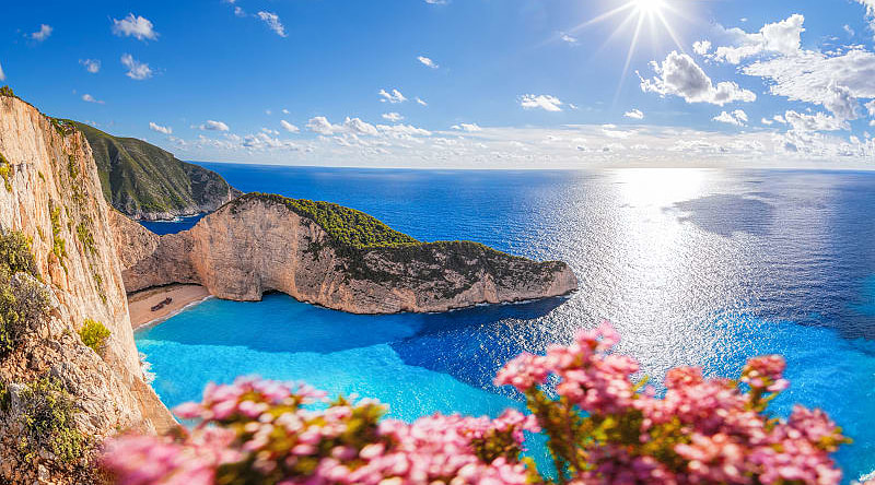 Navagio beach with shipwreck and flowers on Zakynthos island in Greece. Navagio beach with shipwreck and flowers on Zakynthos island in Greece.