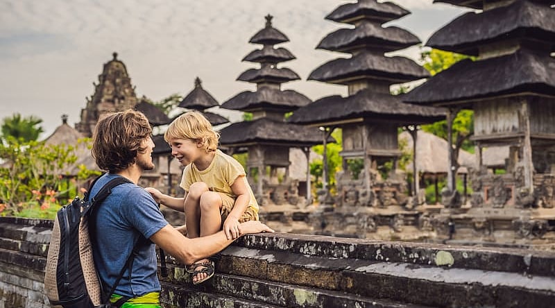Dad and son tourists in traditional Balinese hindu temple