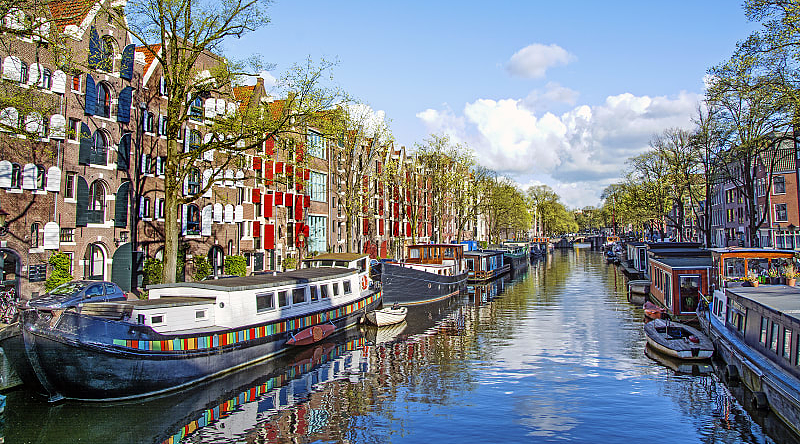 Dutch buildings and canal in Amsterdam, Netherlands Dutch buildings and canal in Amsterdam, Netherlands