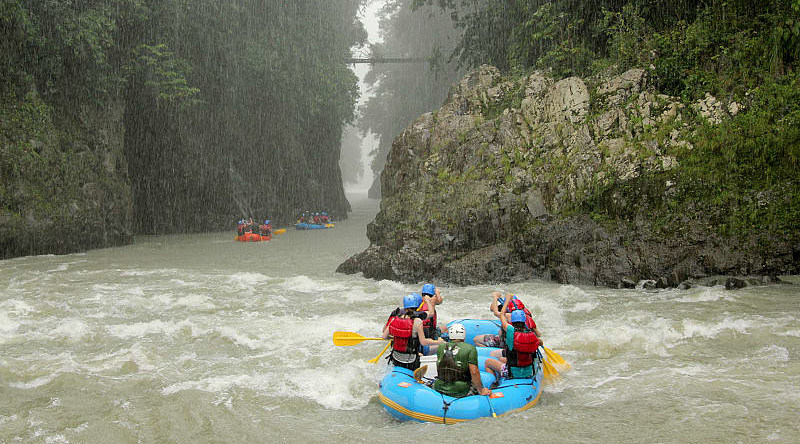 Rafting down the mountain river along the stunning waterfalls Rafting down the mountain river along the stunning waterfalls