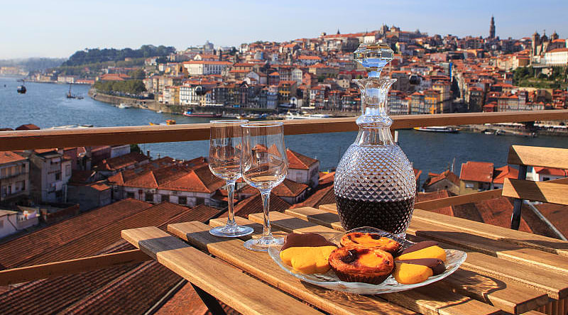 Table set with wine and pastries overlooking Porto, Portugal
