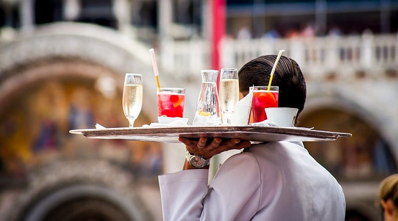 Venice, Italy Waiter serving aperitif drinks in Venice, Italy