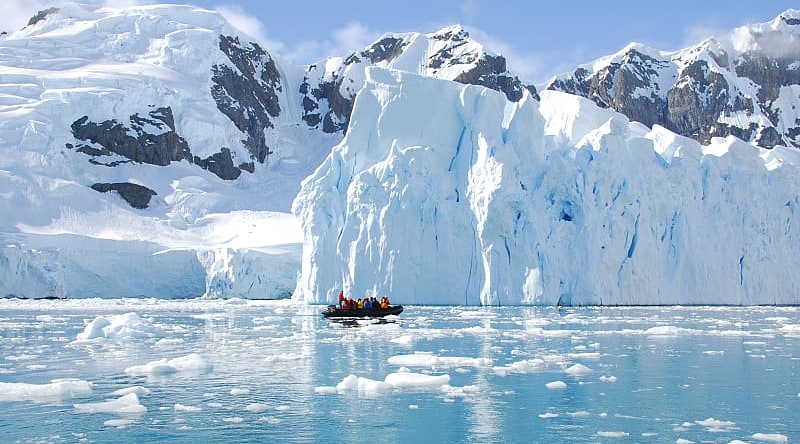 Exploring iceberg off the coast of Antarctica Exploring iceberg off the coast of Antarctica