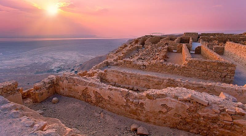 Sunrise over Masada fortress in Judean desert.