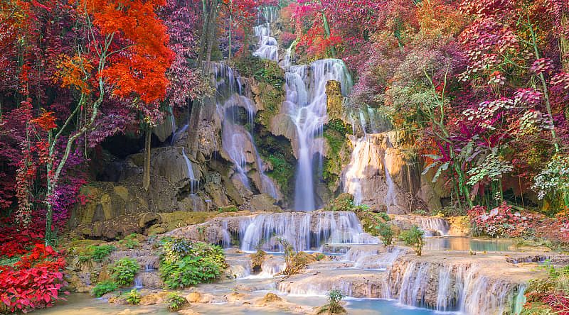 Beautiful autumn colors surround Kuang Si Waterfall in Luang Prabang, Laos.