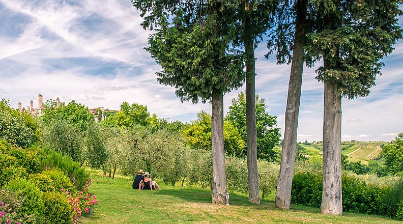 Couple relaxing and enjoying the view of the Tuscany countryside in Italy