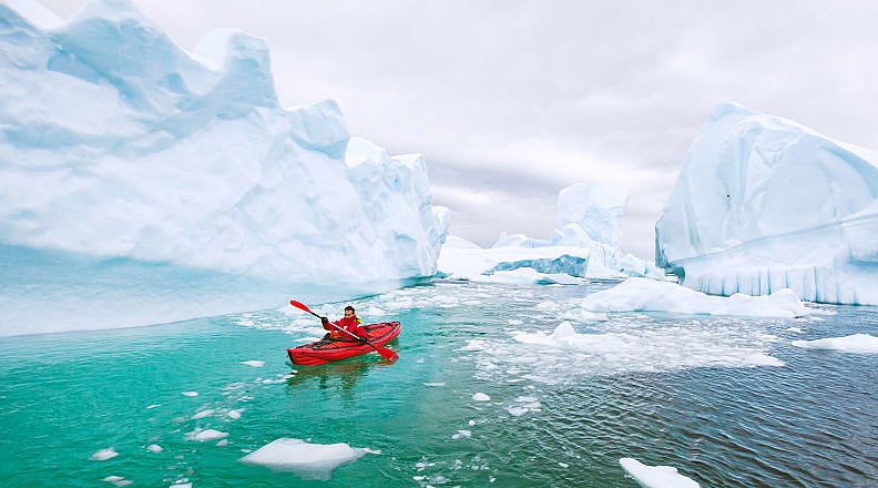 Kayaking around icebergs in Antarctica