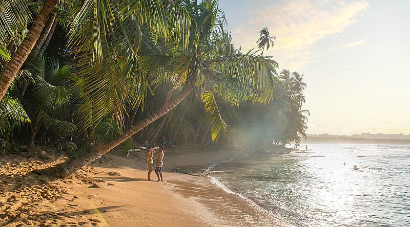 Couple at paradise beach of Manzanillo Park in Costa Rica