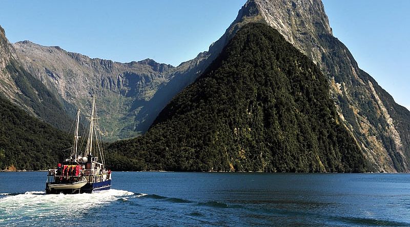 Ship under Mitra Peak in Fiordland National Park on South Island, New Zealand