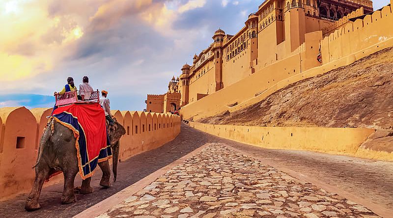 Senior tourists enjoy elephant ride at Amer Fort in Jaipur, India