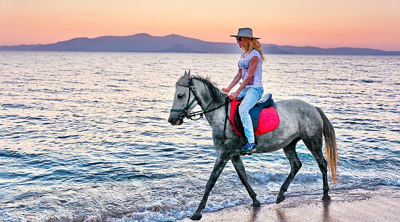 Horseback riding on the beach in Greece.