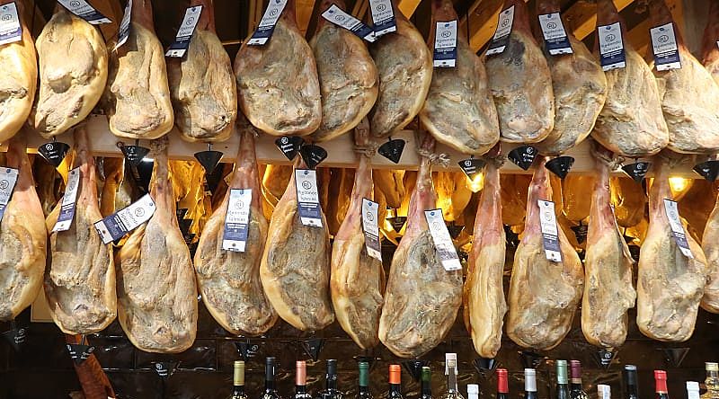 Jamon and wine for sale at a market in Spain.