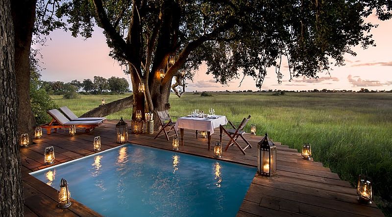 Guest private dining on the pool deck at Duba Plains Camp in the Okavango Delta, Botswana