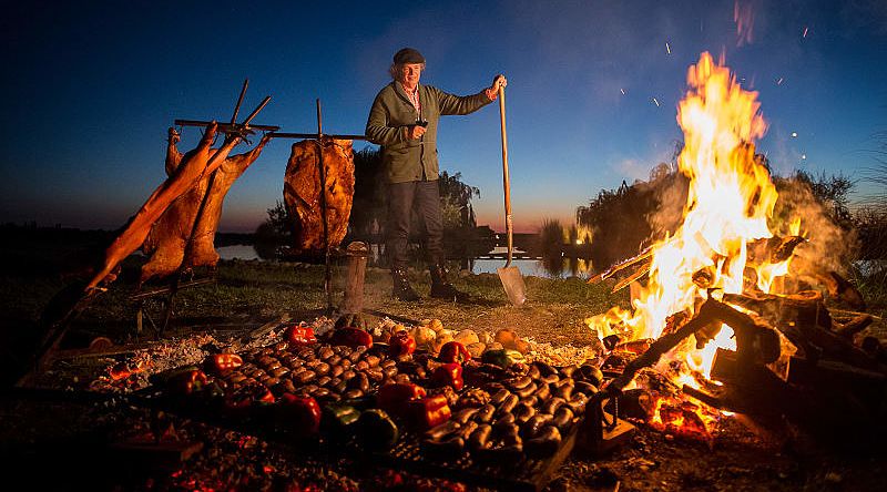 Chef Francis Mallmann tends the fires at Siete Fuegos restaurant in Mendoza, Argentina