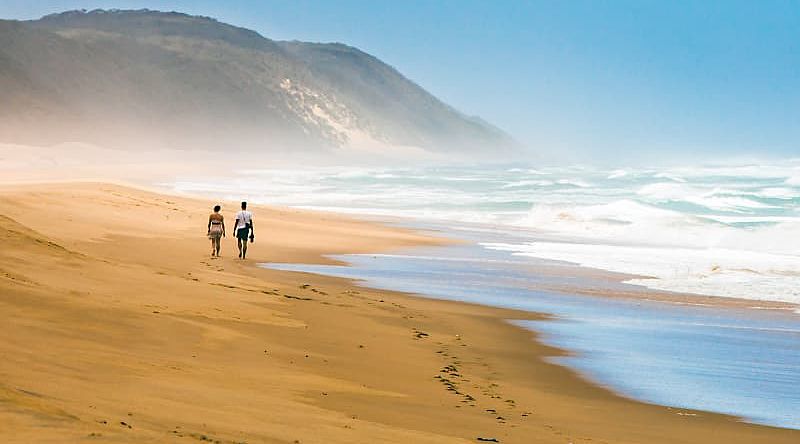 Couple walking on the beach in South Africa Couple walking on the beach in South Africa