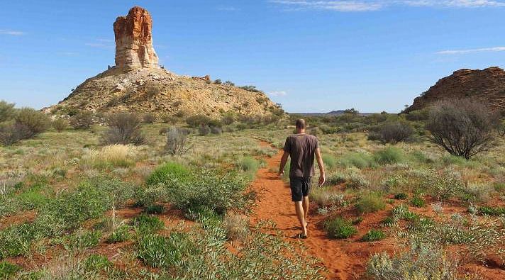 Hiker at Chambers pillar in northern Australia Hiker at Chambers pillar in northern Australia