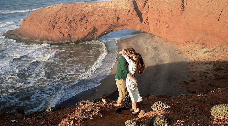 Couple at Legzira Beach near Agadir, Morocco