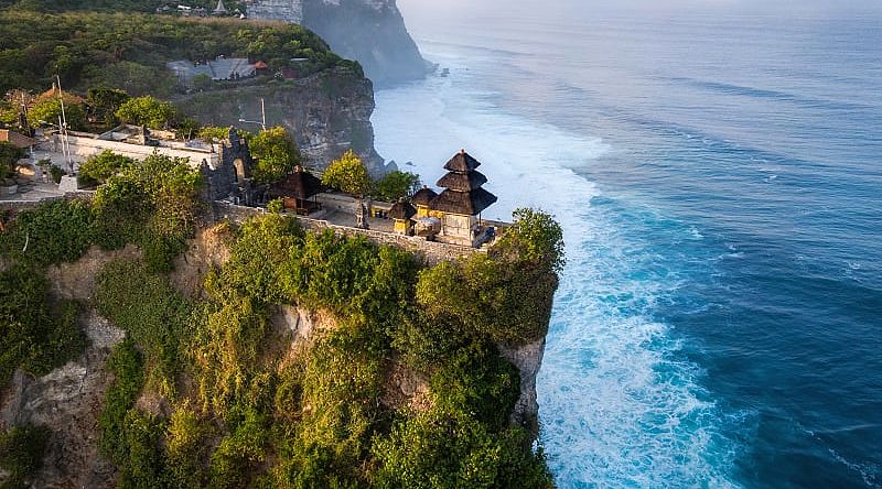 Cliffside Pura Luhur Uluwatu Temple at sunrise in Bali, Indonesia