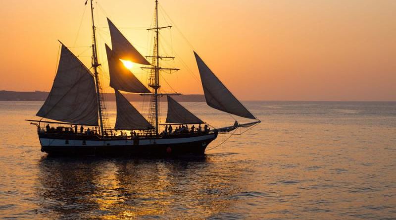 Enjoy a delightful sunset on a boat cruise around Santorini