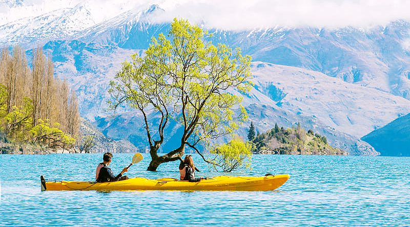 Couple kayaking Lake Wanaka in New Zealand Couple kayaking Lake Wanaka in New Zealand